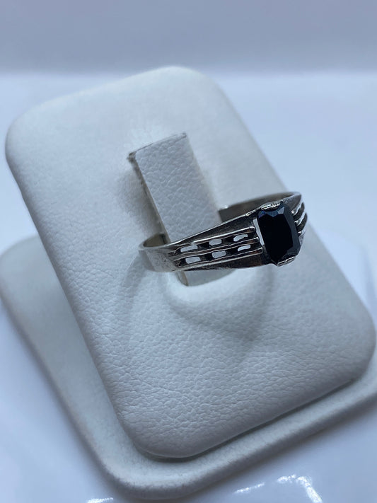 Detalle lateral del anillo minimalista en plata .925 mostrando el engaste de la circonia negra