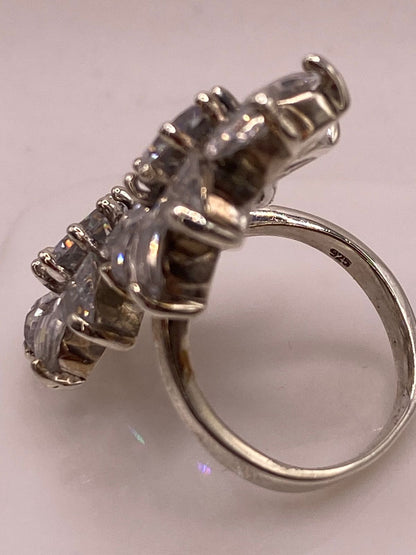 Vista frontal de anillo doble flor de plata .925 con circonias transparentes en gota y redondas — diseño tridimensional Taxco