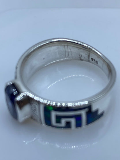 Anillo Greca de Plata .950 con Ópalo de Fuego y Zirconia Azul, sello de autenticidad Plata Ley .925