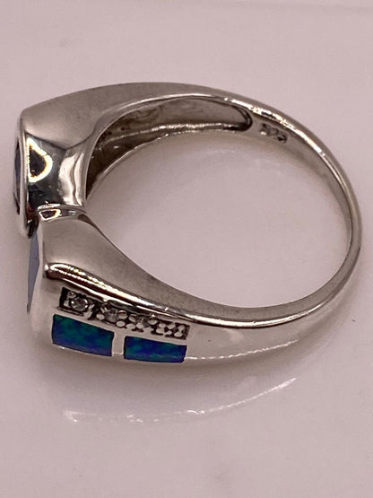 Anillo con Ópalo de Fuego y Zirconia Azul Iridiscente en Plata Ley .925, sello de autenticidad Plata Ley .925