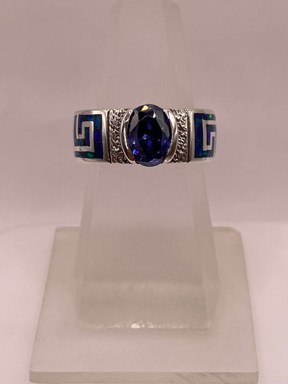 Anillo de Plata .950 con Ópalo de Fuego y Zirconia Azul – Diseño Greca, vista lateral