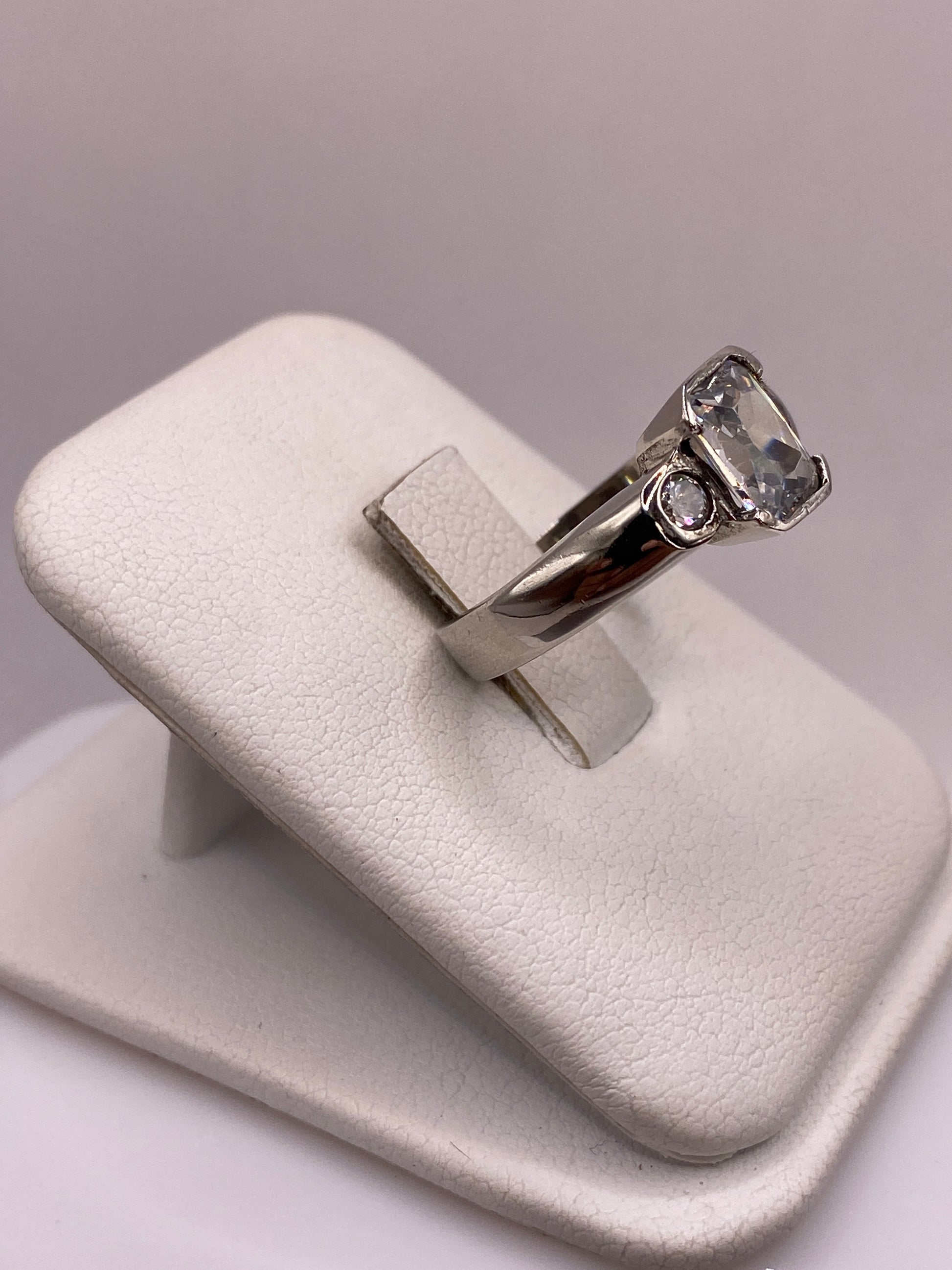 Detalle lateral del anillo mostrando la banda gruesa y el engaste de la circonia
