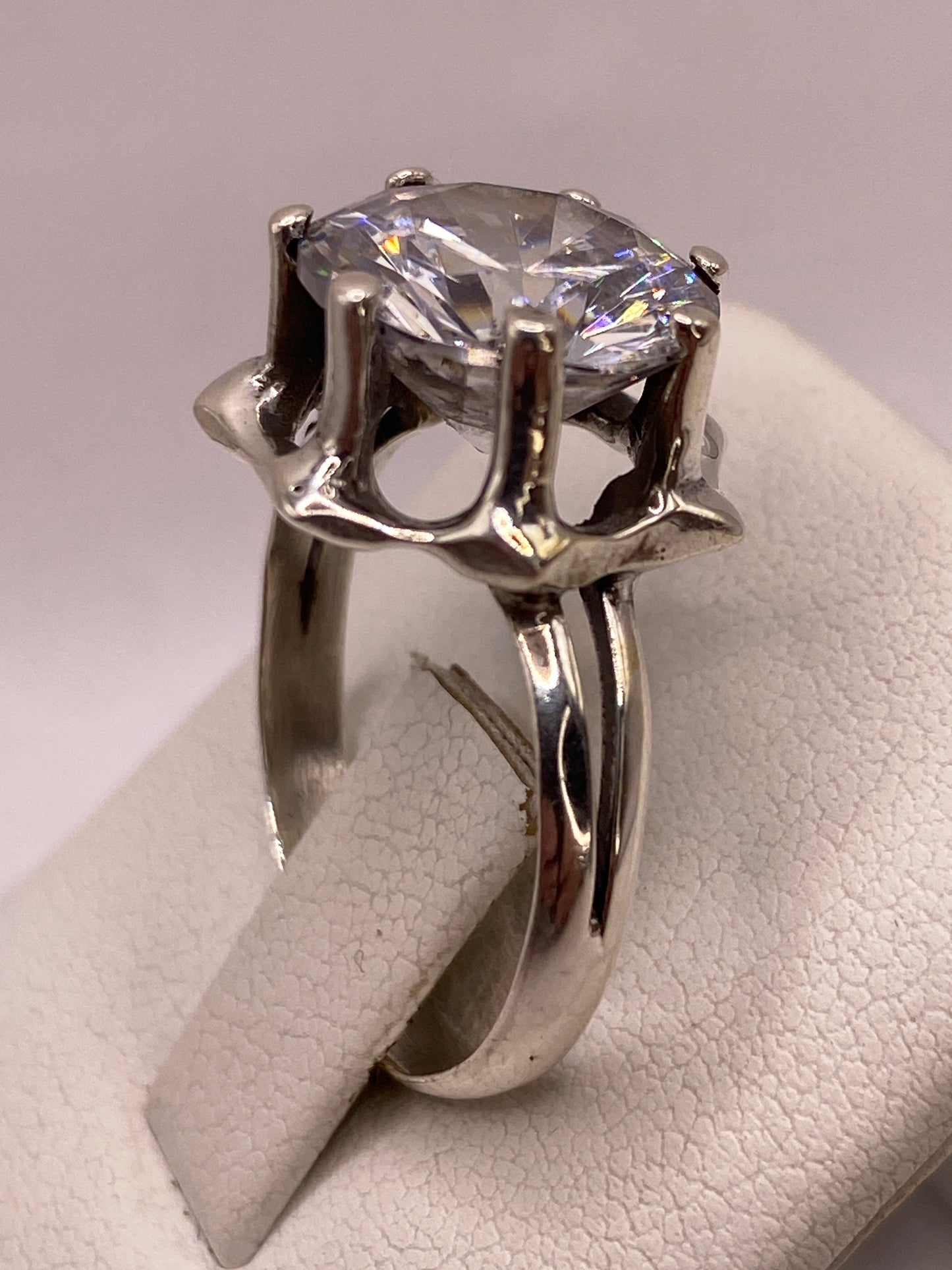 Anillo solitario puesto en la mano mostrando el brillo tipo diamante de la circonia