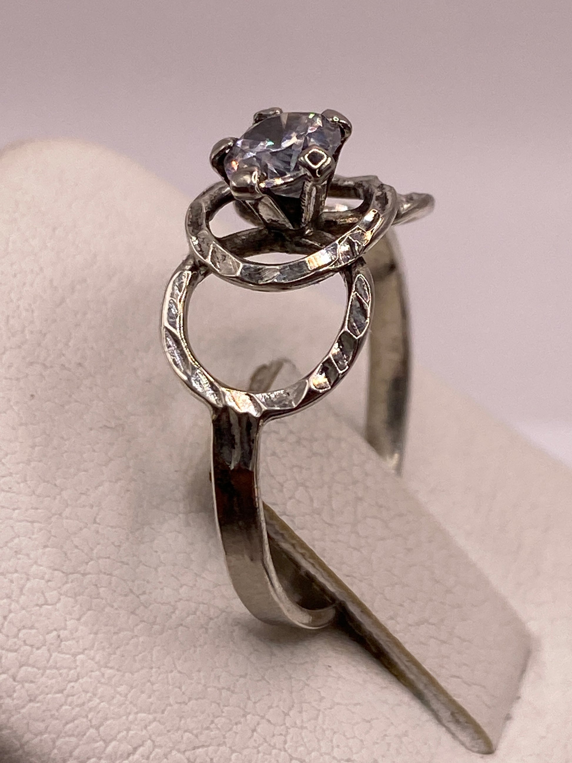 Anillo solitario en la mano mostrando el brillo y la elegancia del diseño