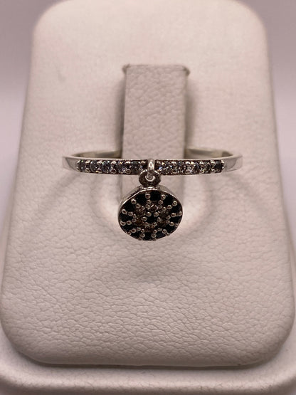 Anillo de plata solitario con circonia blanca brillante en la mano de una mujer