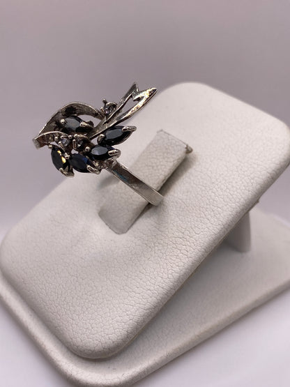Anillo vintage en plata sobre dedo, mostrando la banda calada con motivos geométricos