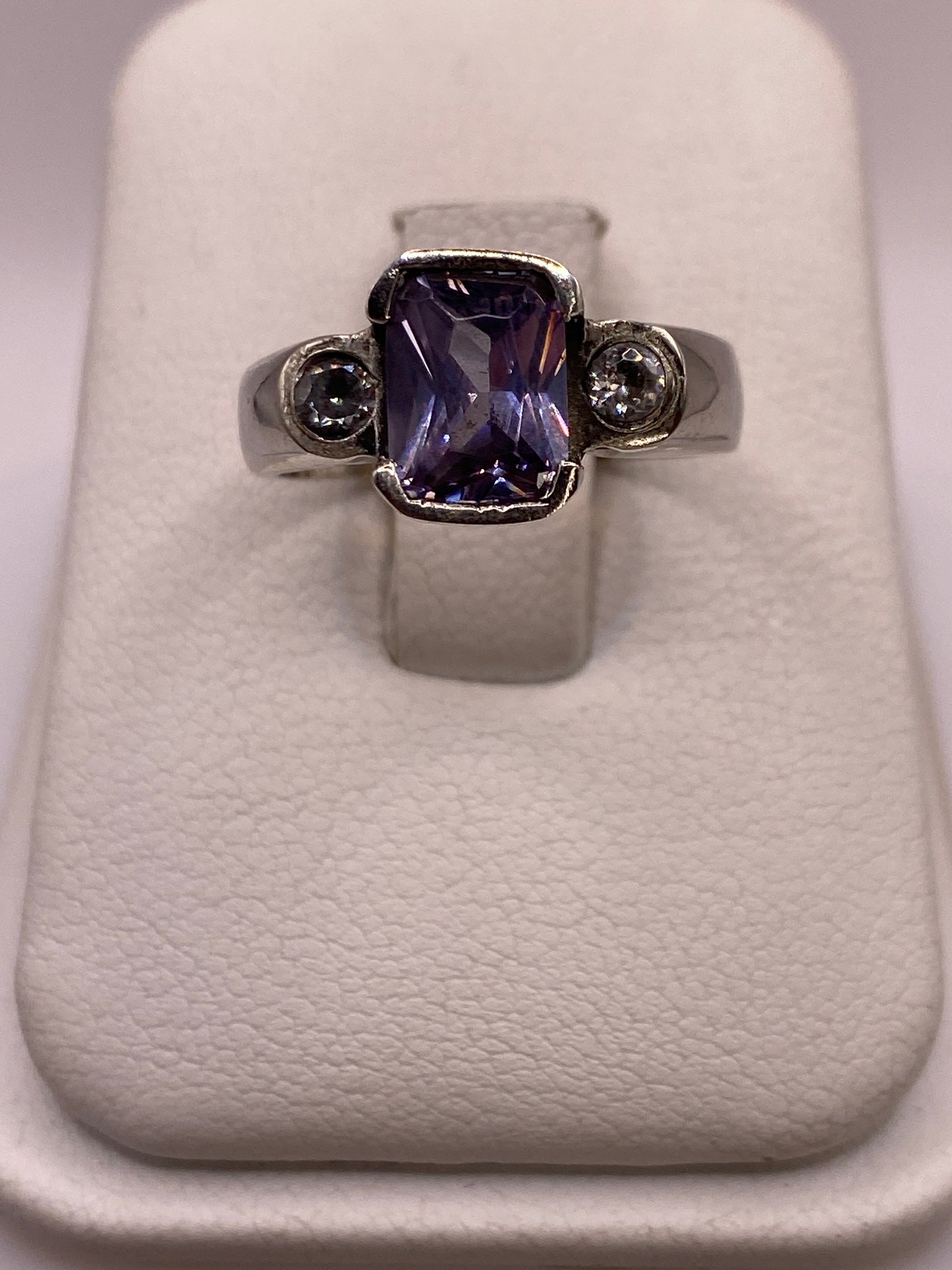 Anillo solitario de plata con circonia violeta profunda en caja de presentación blanca