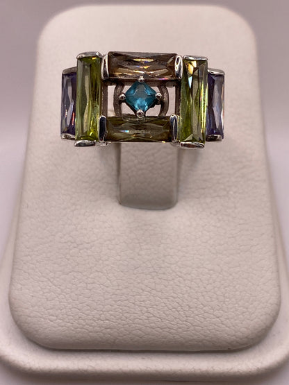 Anillo de plata .925 con circonias azul, ámbar y violeta en estructura geométrica
