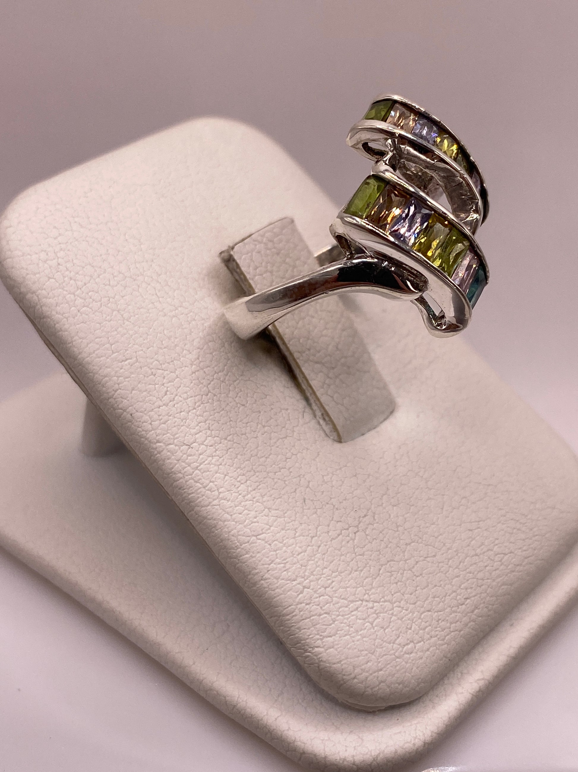 Vista frontal del anillo de plata con bandas paralelas envolventes y coronas de circonia baguette