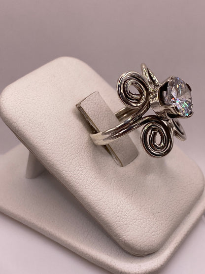 Anillo solitario con espirales artesanales y circonia brillante visto de frente