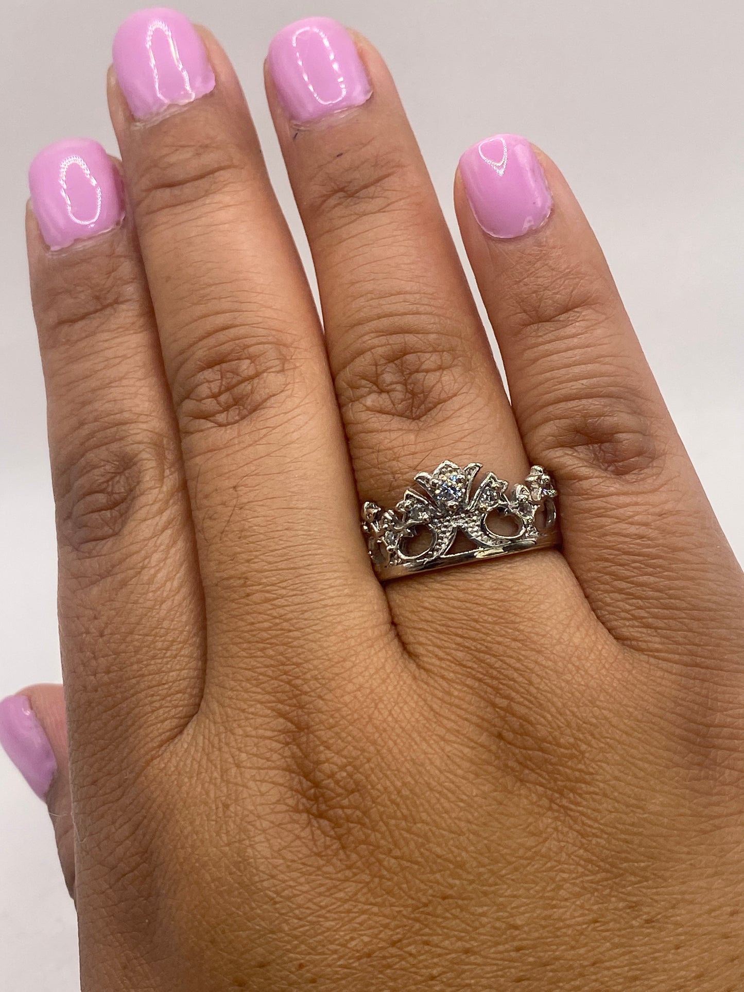 Anillo solitario en la mano mostrando el brillo de la piedra y el sello de autenticidad