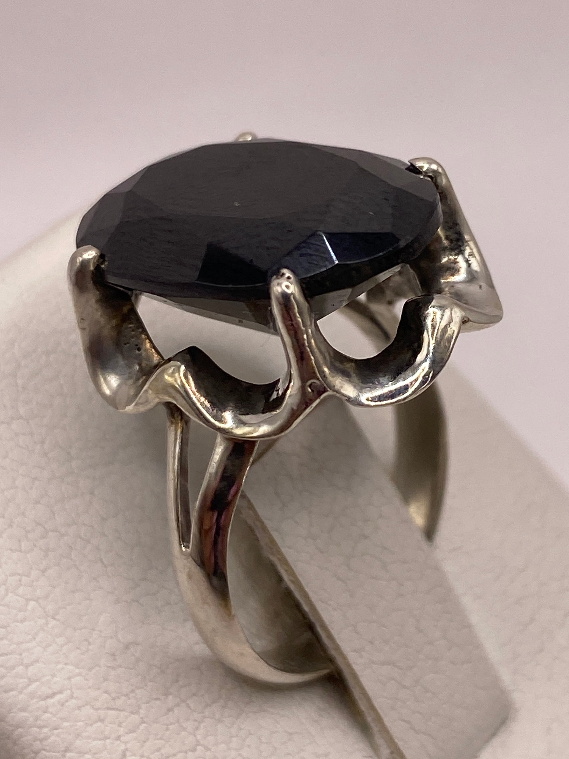 Anillo de circonia negra puesto en mano, destacando el brillo facetado
