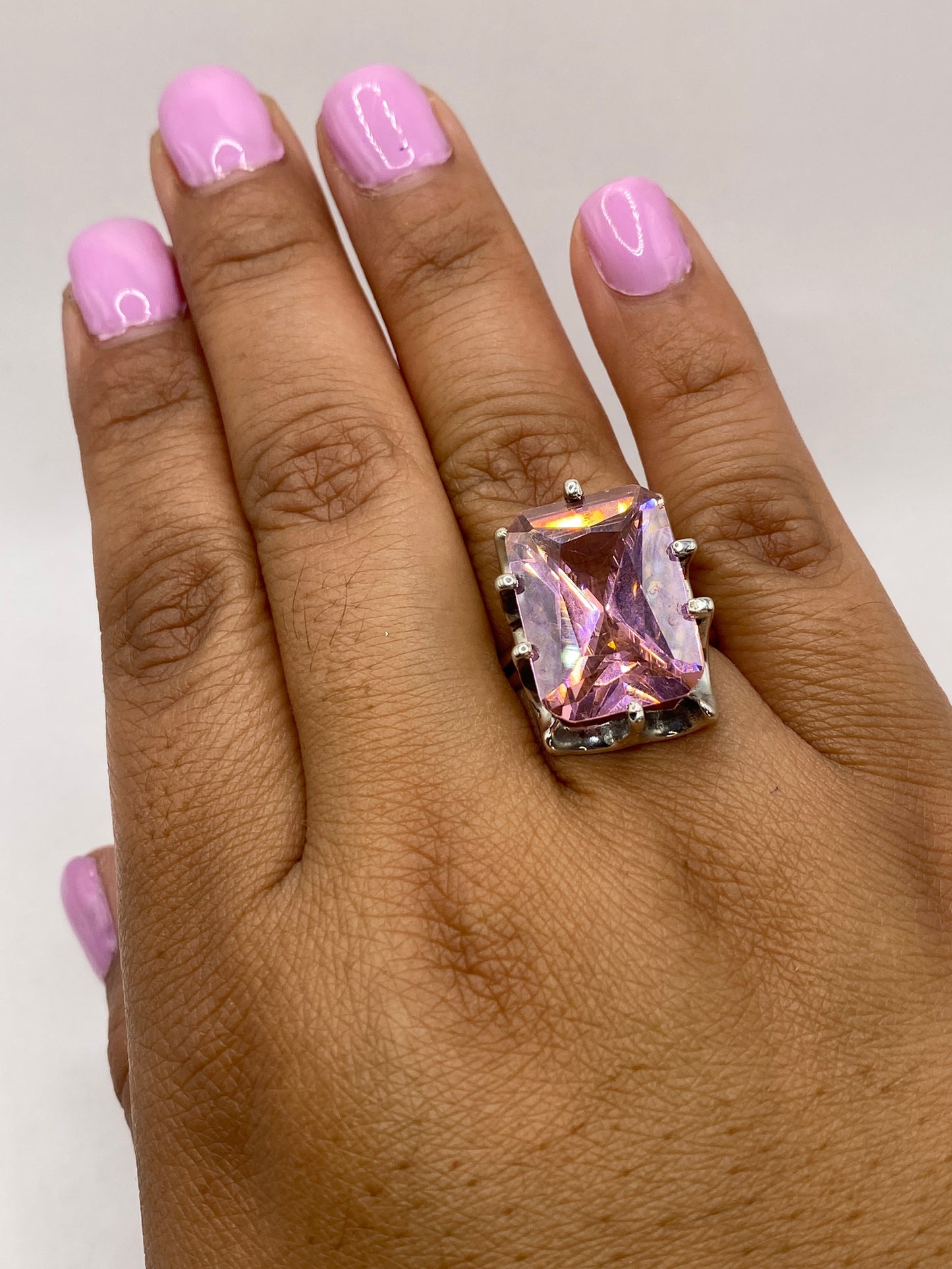Anillo en dedo mostrando el tamaño y presencia real de la piedra rosa