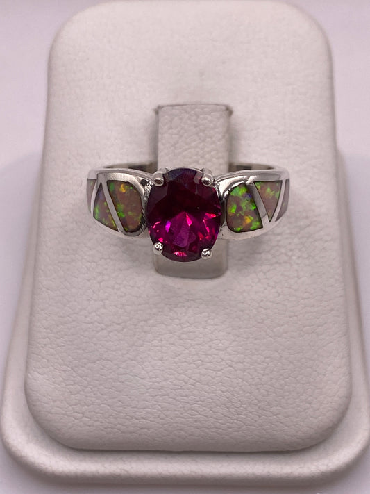 Anillo de plata .925 con ópalo de fuego multicolor engastado a mano, sobre dedo de mujer