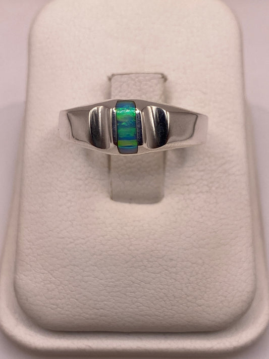 Anillo de plata con ópalo de fuego azul cielo en bandas geométricas, vista frontal en dedo