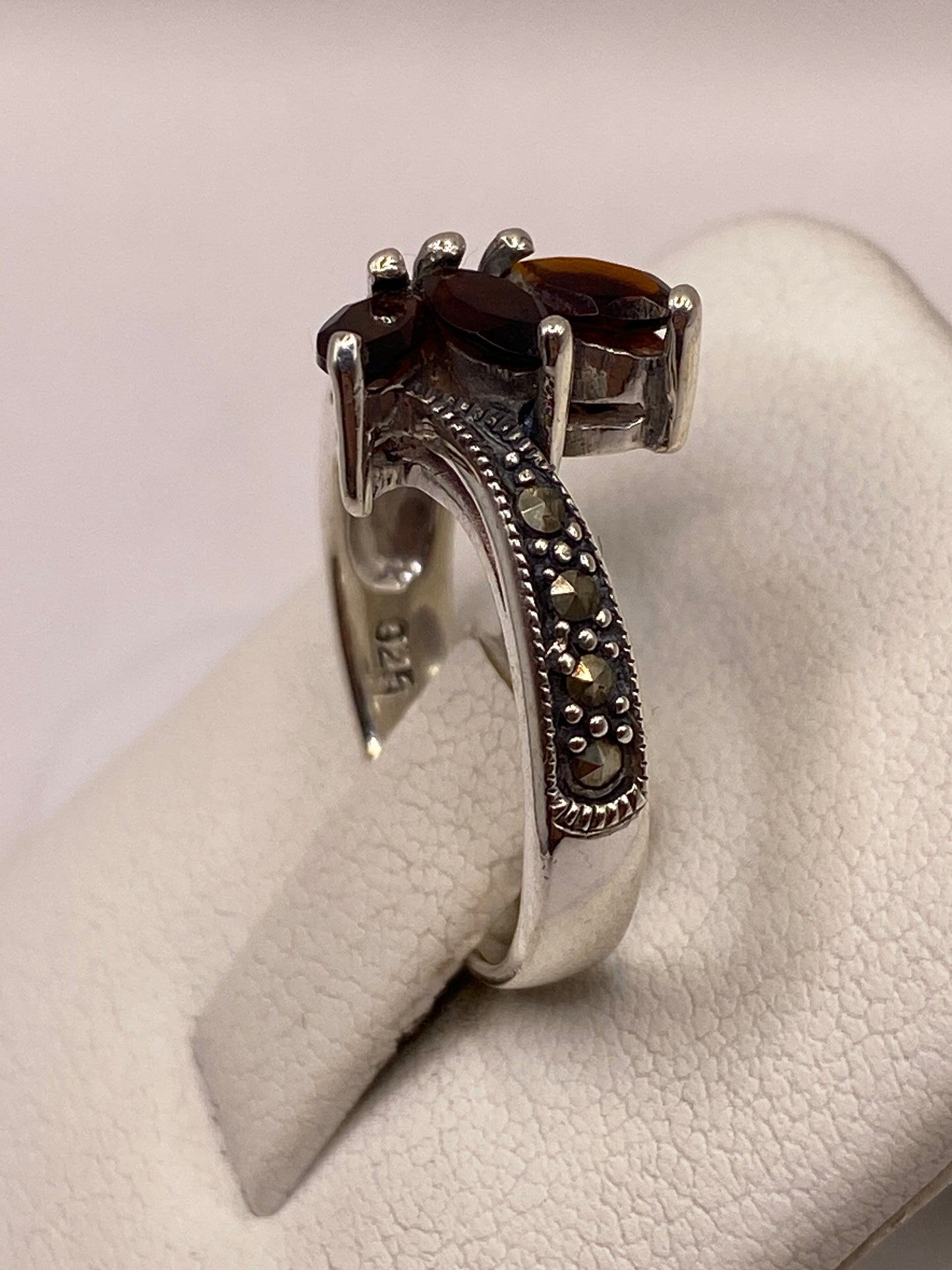 Anillo de circonia café en la mano, luciendo el brillo cálido de la piedra bajo luz natural