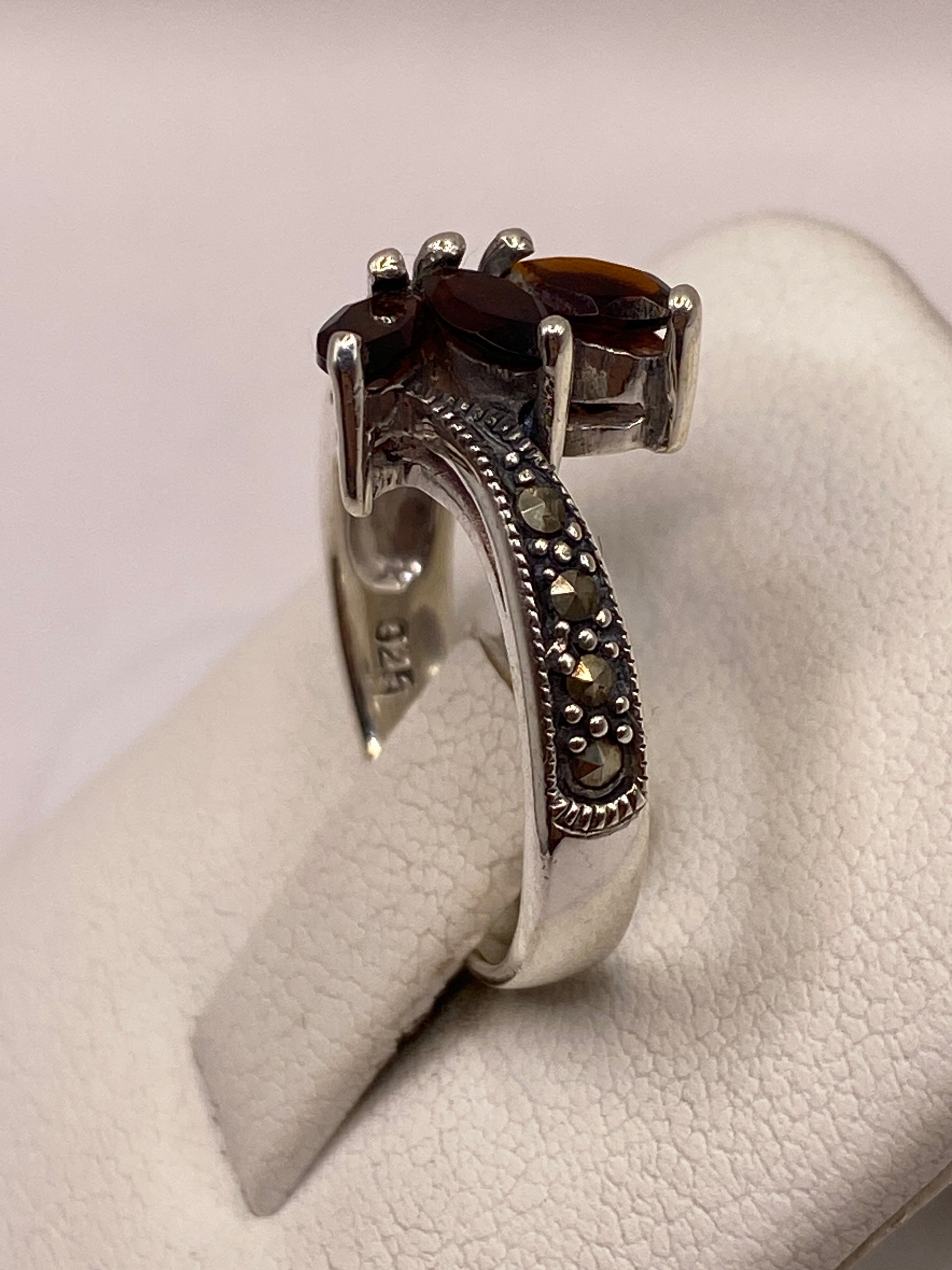 Anillo de circonia café en la mano, luciendo el brillo cálido de la piedra bajo luz natural