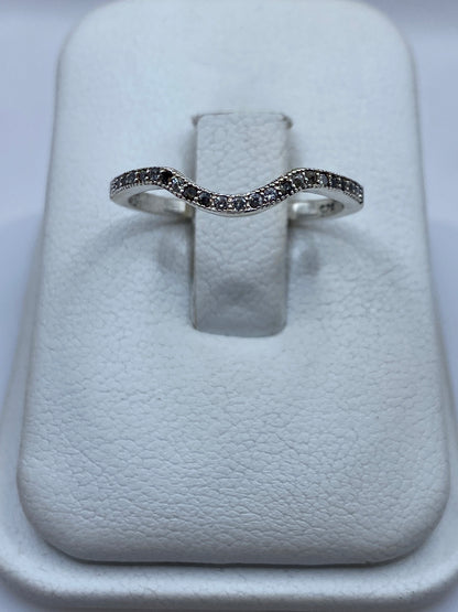 Anillo de plata curva minimalista con circonia blanca en vitrina