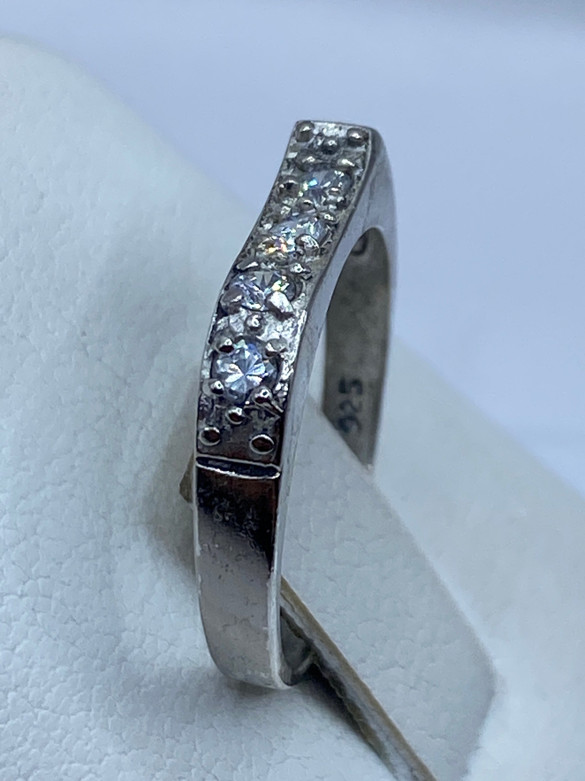 Detalle lateral del anillo solitario mostrando el engaste de circonia en plata pura