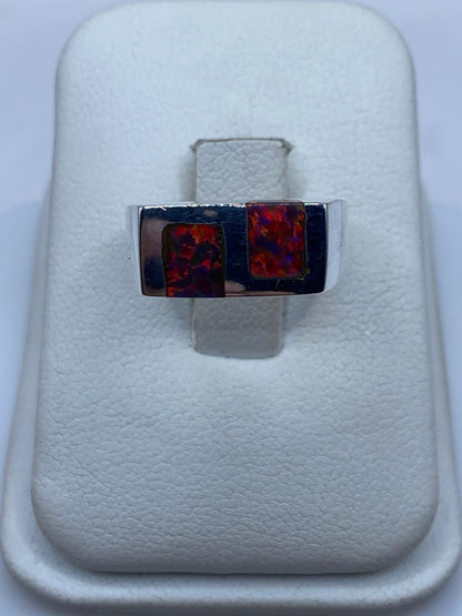 Anillo de plata .950 con dos ópalos de fuego multicolor en diseño geométrico, talla 5