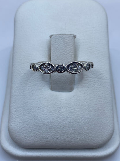 Anillo de plata con línea de circonias blancas en la mano de una mujer