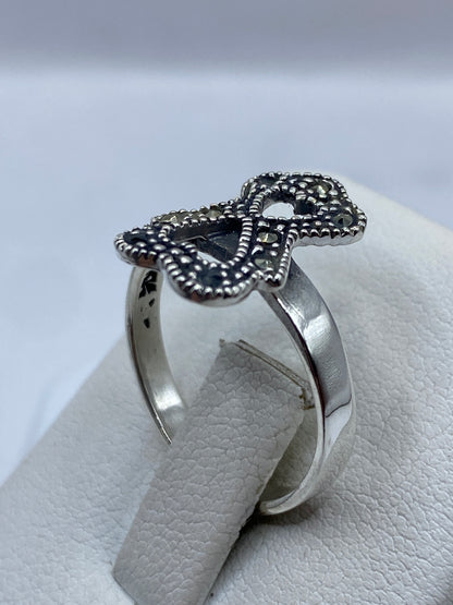 Anillo minimalista lazo sobre fondo blanco mostrando pulido brillante