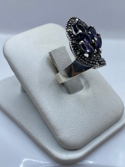 Vista frontal del anillo elegante con frente de circonia morada y banda de plata .925