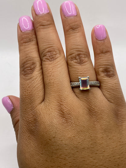 Anillo solitario circonia multicolor en dedo femenino con esmalte rosa