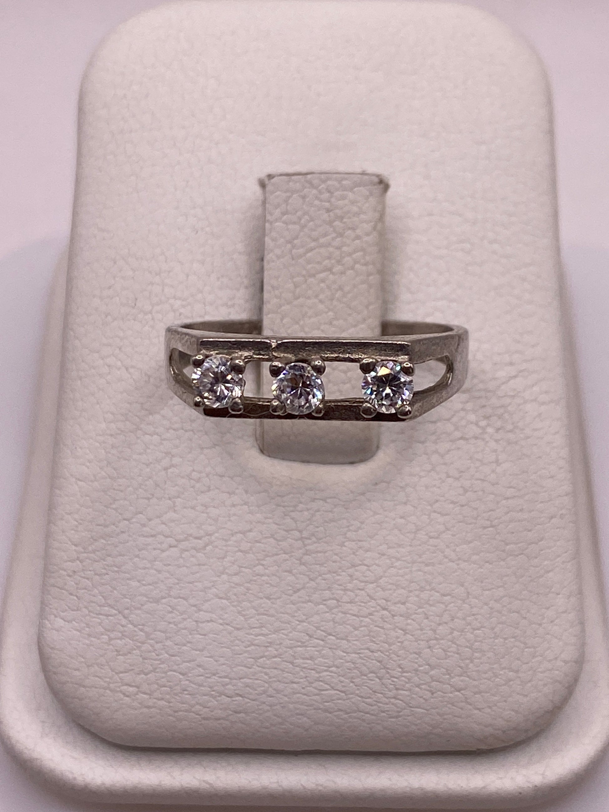 Anillo de plata solitario con circonia blanca en la mano de una mujer