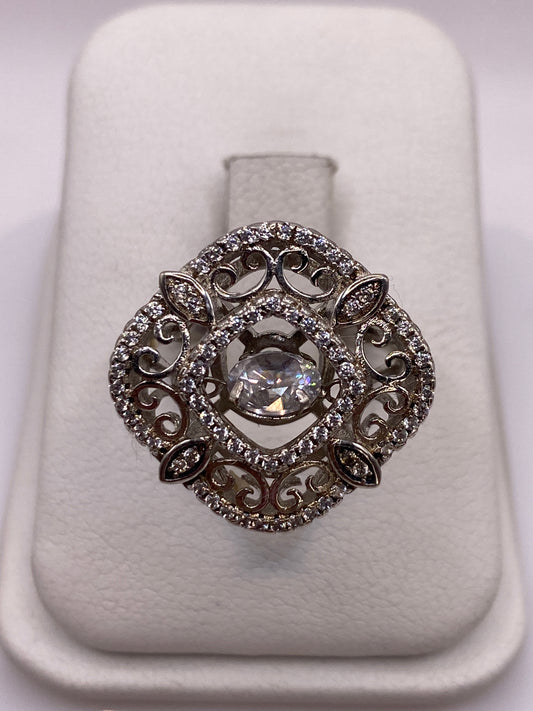 Anillo vintage de plata .925 con circonia blanca en filigrana ornamental, visto de frente