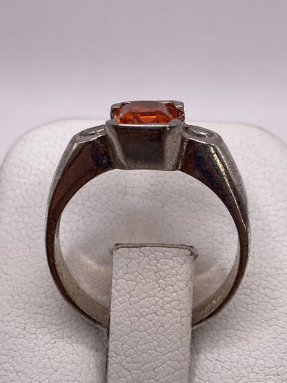 Vista frontal del anillo de plata .925 con piedra naranja facetada