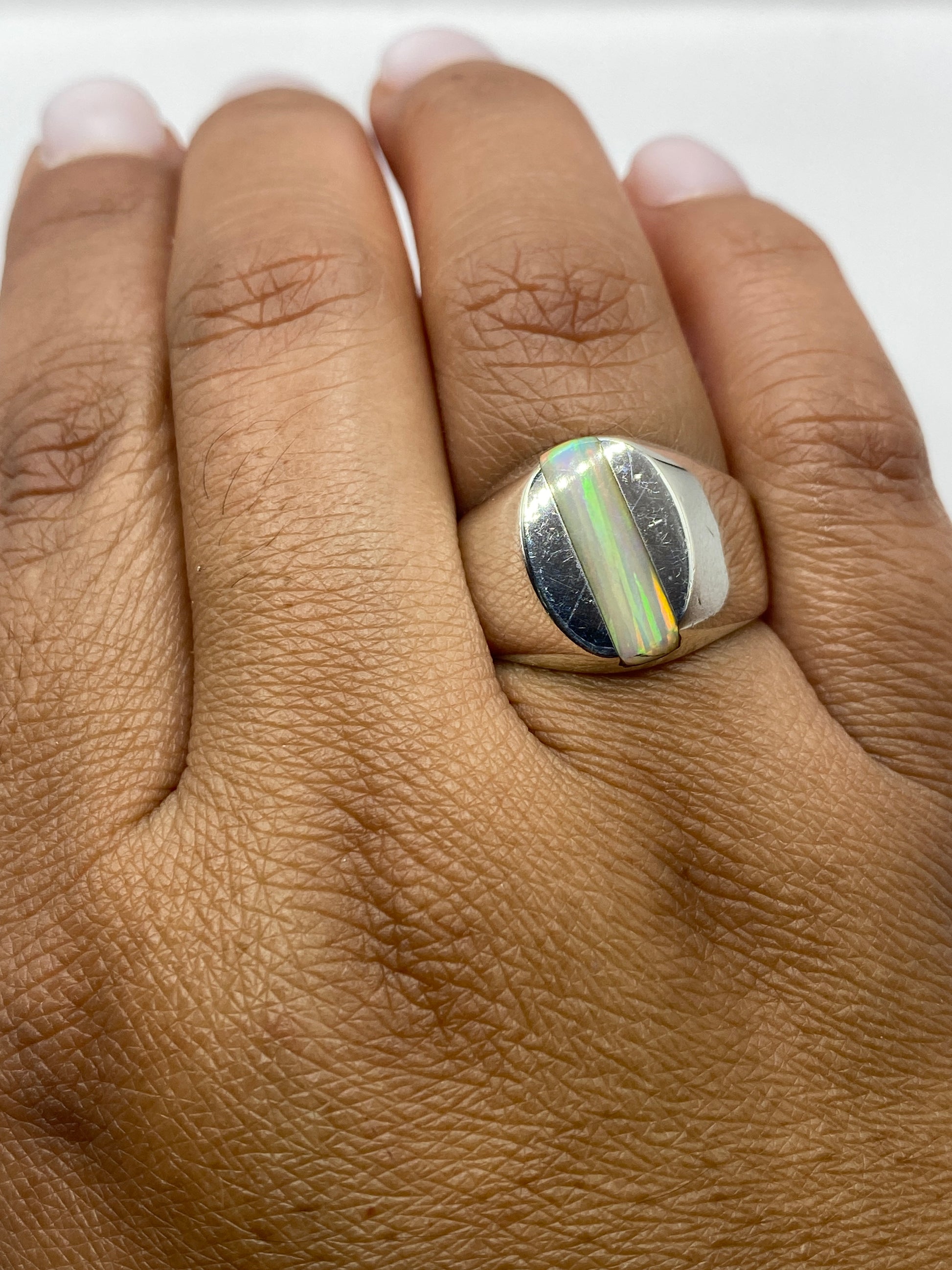 Anillo en la mano mostrando el sello 925 y la banda pulida de Taxco