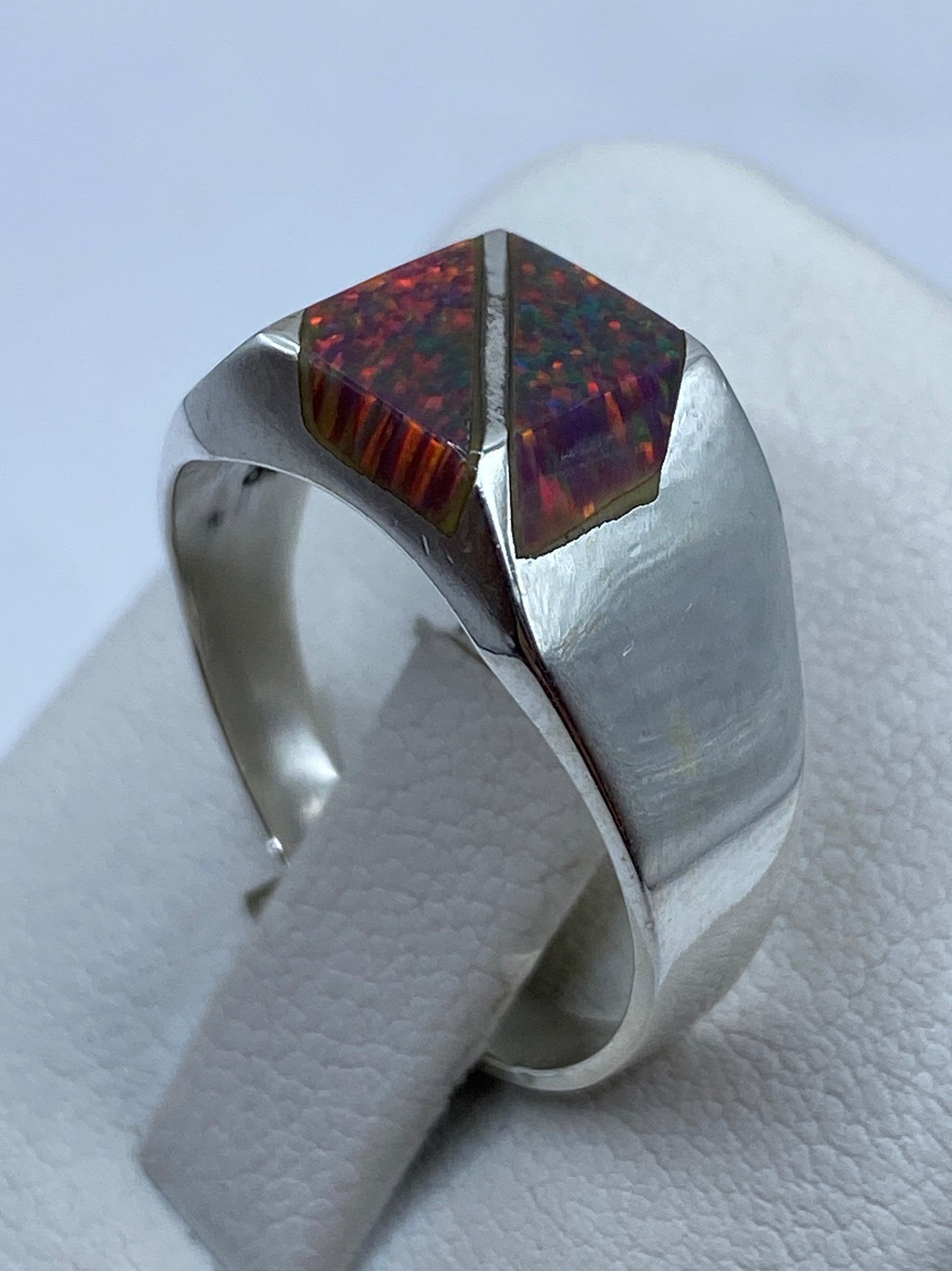 Anillo en la mano luciendo el juego de colores natural del ópalo