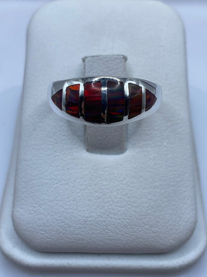 Anillo de plata .950 con ópalo de fuego multicolor visto de frente, mostrando reflejos rojos, naranjas y amarillos