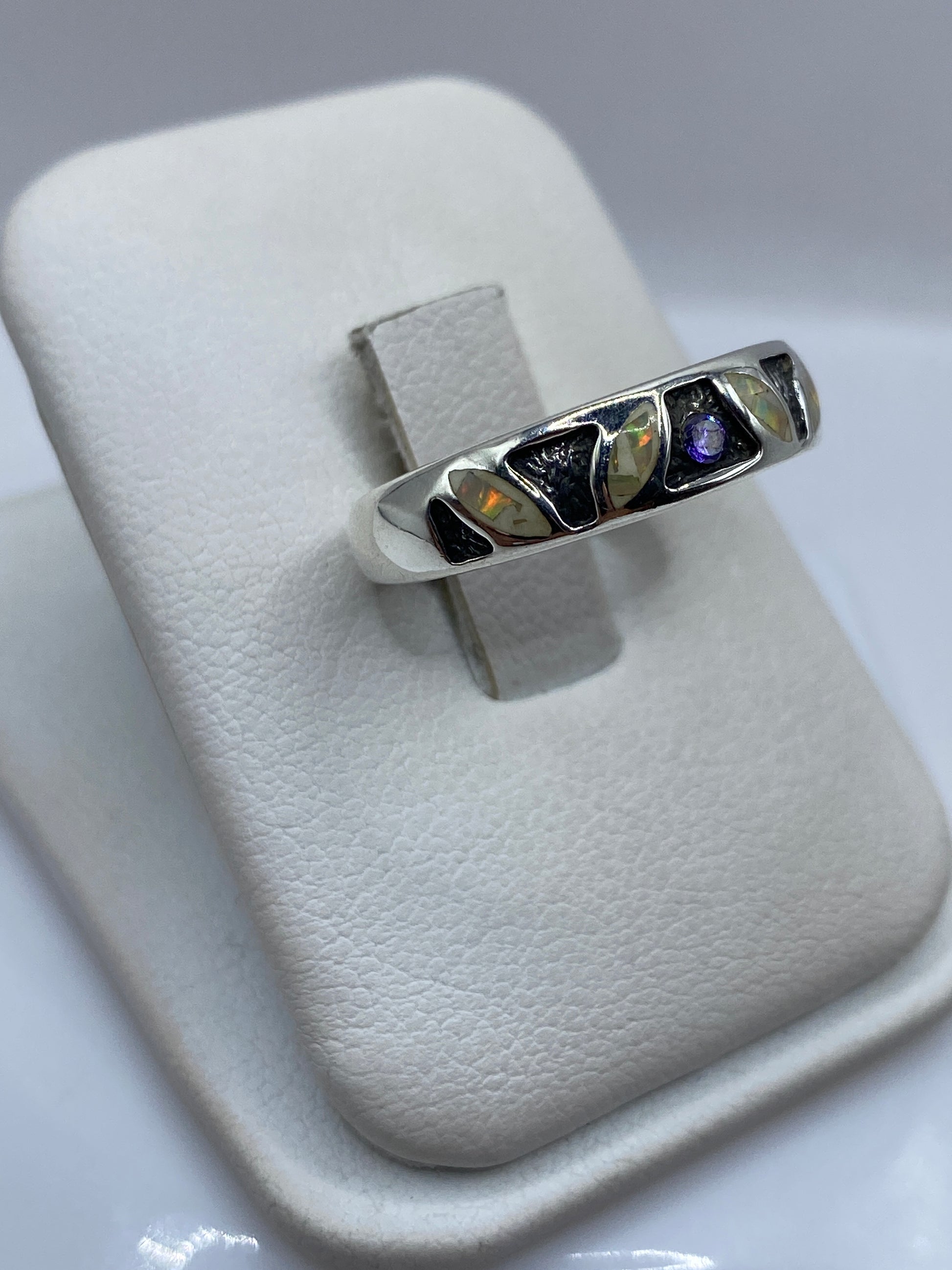 Detalle frontal del anillo ópalo mostrando juego de colores rojo, naranja y amarillo