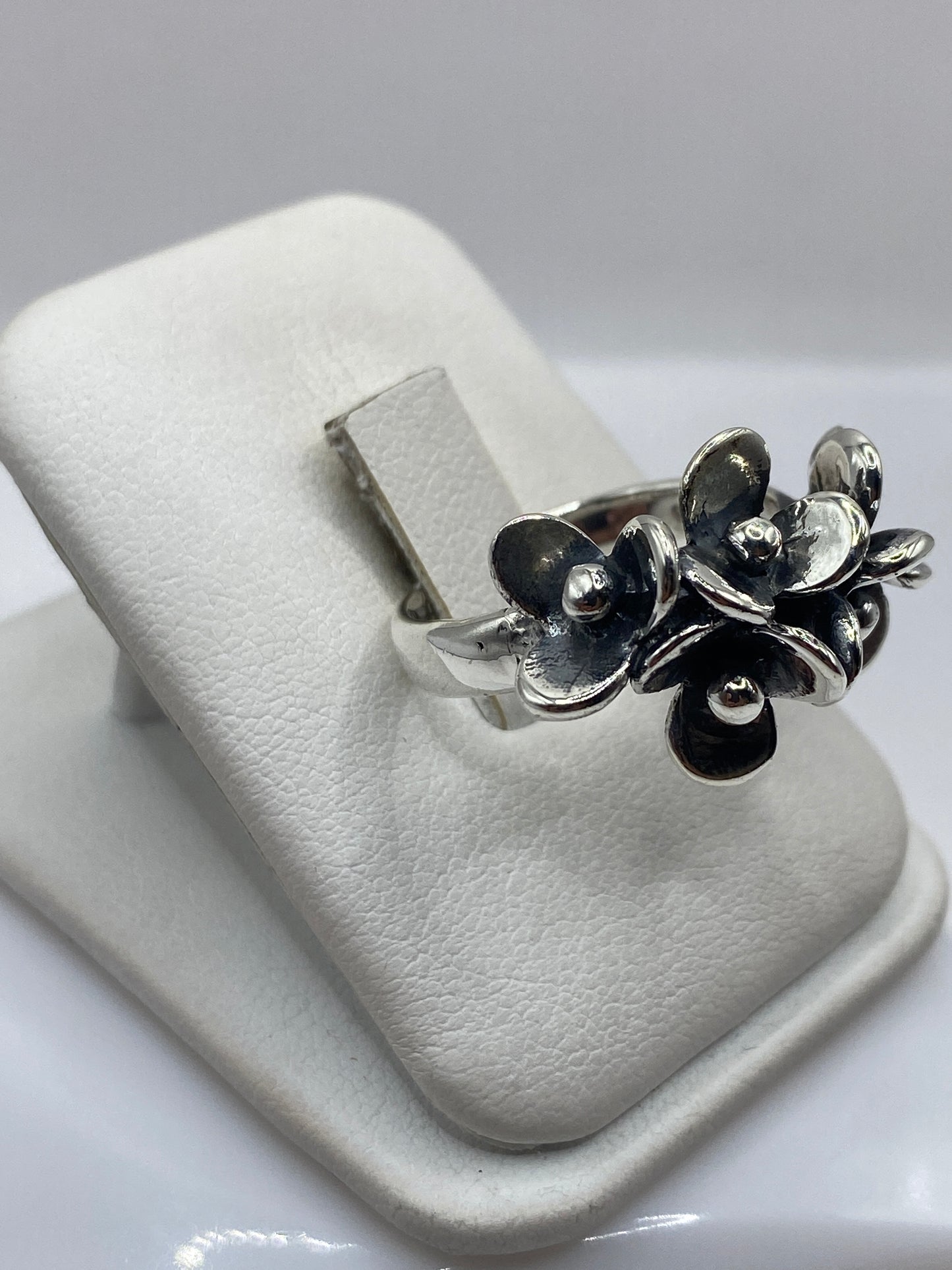Anillo florales en plata .925 en la mano de una mujer, mostrando movimiento y volumen
