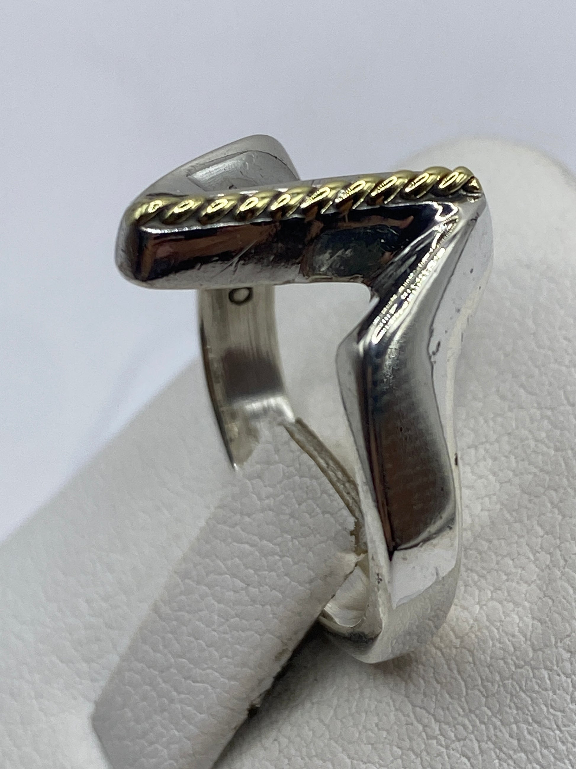 Anillo en la mano mostrando el diseño geométrico y brillo de plata .925