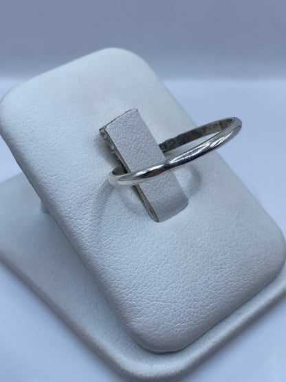 Anillo minimalista de plata en dedo, mostrando el brillo pulido