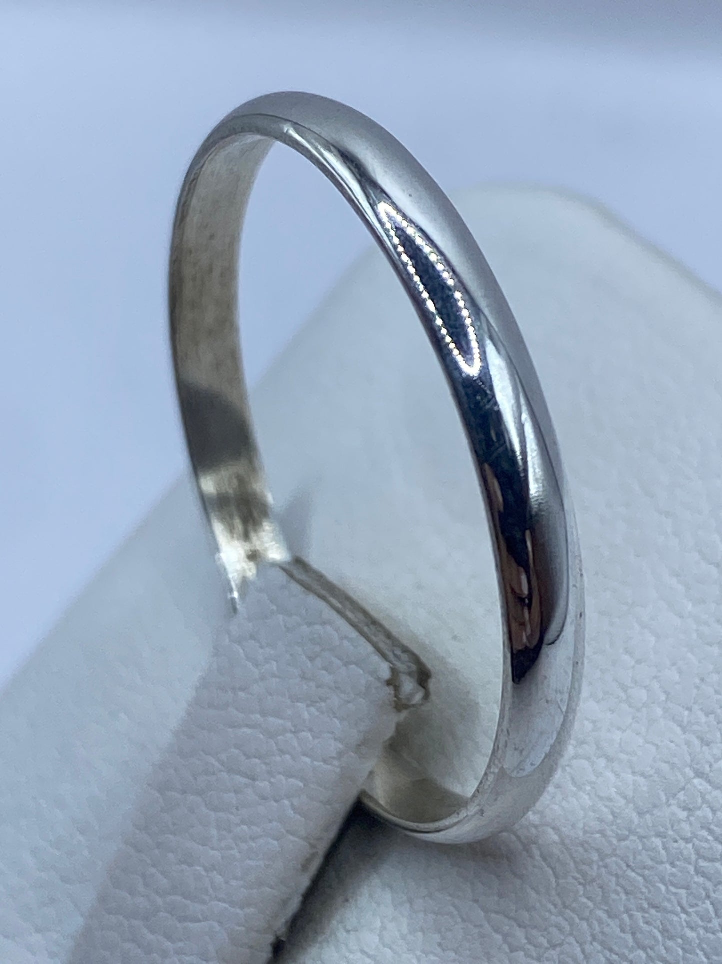 Anillo banda en dedo mostrando el acabado liso y brillante