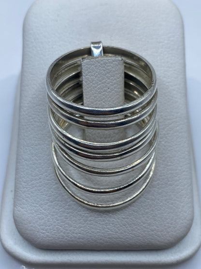 Anillo de plata apilable bandas lisas minimalista en la mano de una mujer
