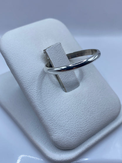 Anillo clásico de plata en perfil lateral, mostrando el pulido brillante