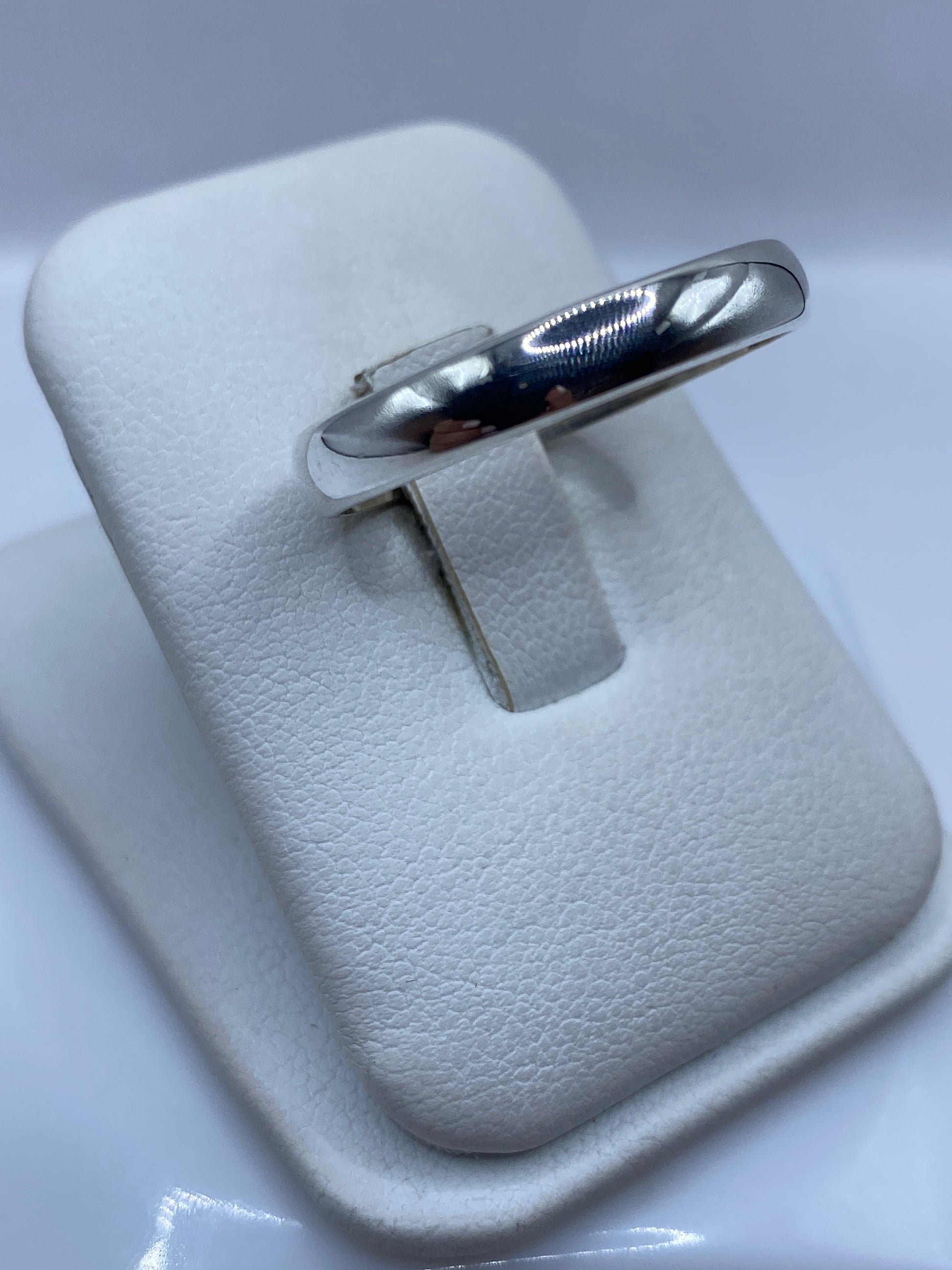 Anillo de plata banda redondeada en dedo masculino, detalle lateral