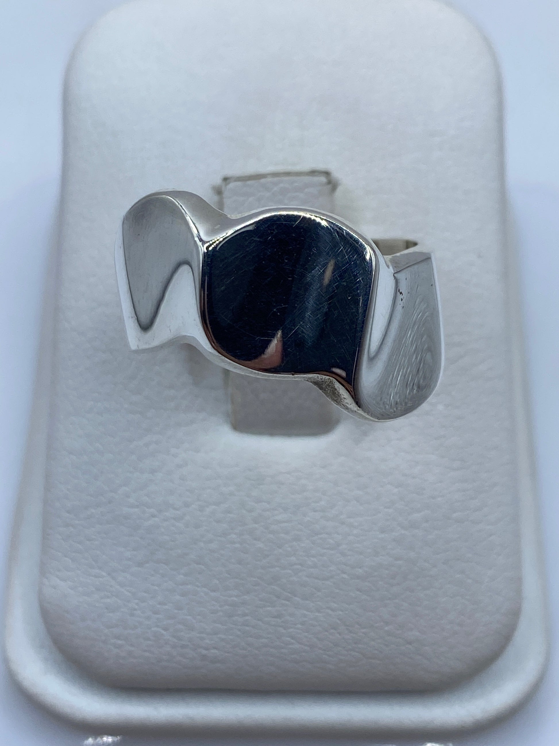 Anillo de plata minimalista con forma orgánica fluida en dedo de mujer
