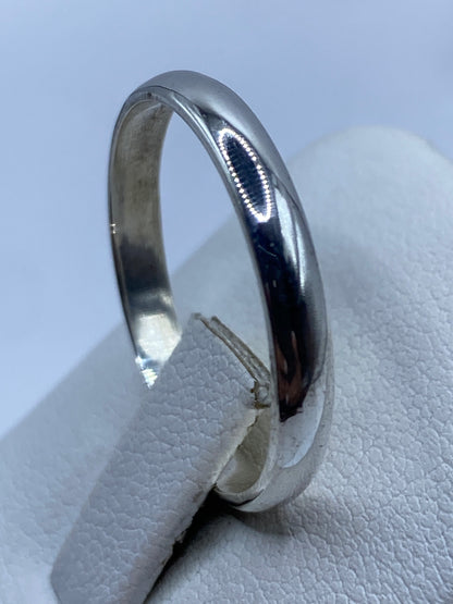 Anillo banda de plata .925 en la mano, mostrando el acabado y el sello 925