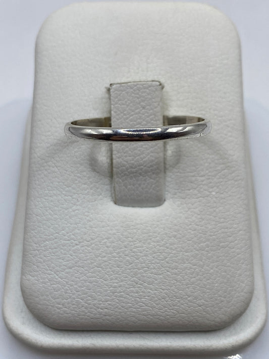 Anillo de plata banda pulida minimalista en dedo de mujer