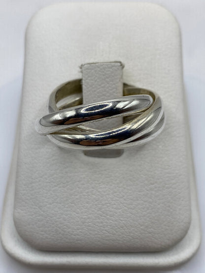 Anillo de plata entrelazado con tres bandas pulidas en mano femenina