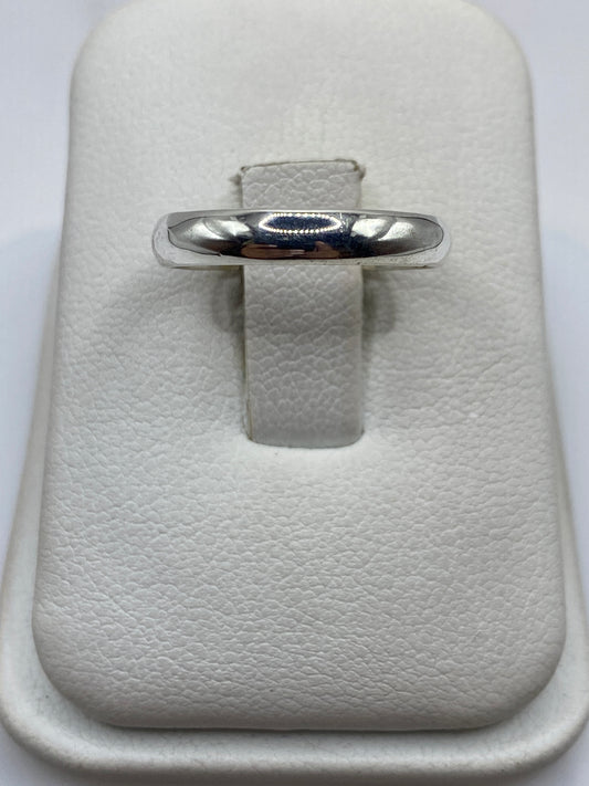 Anillo de plata banda pulida minimalista en estuche blanco, frente