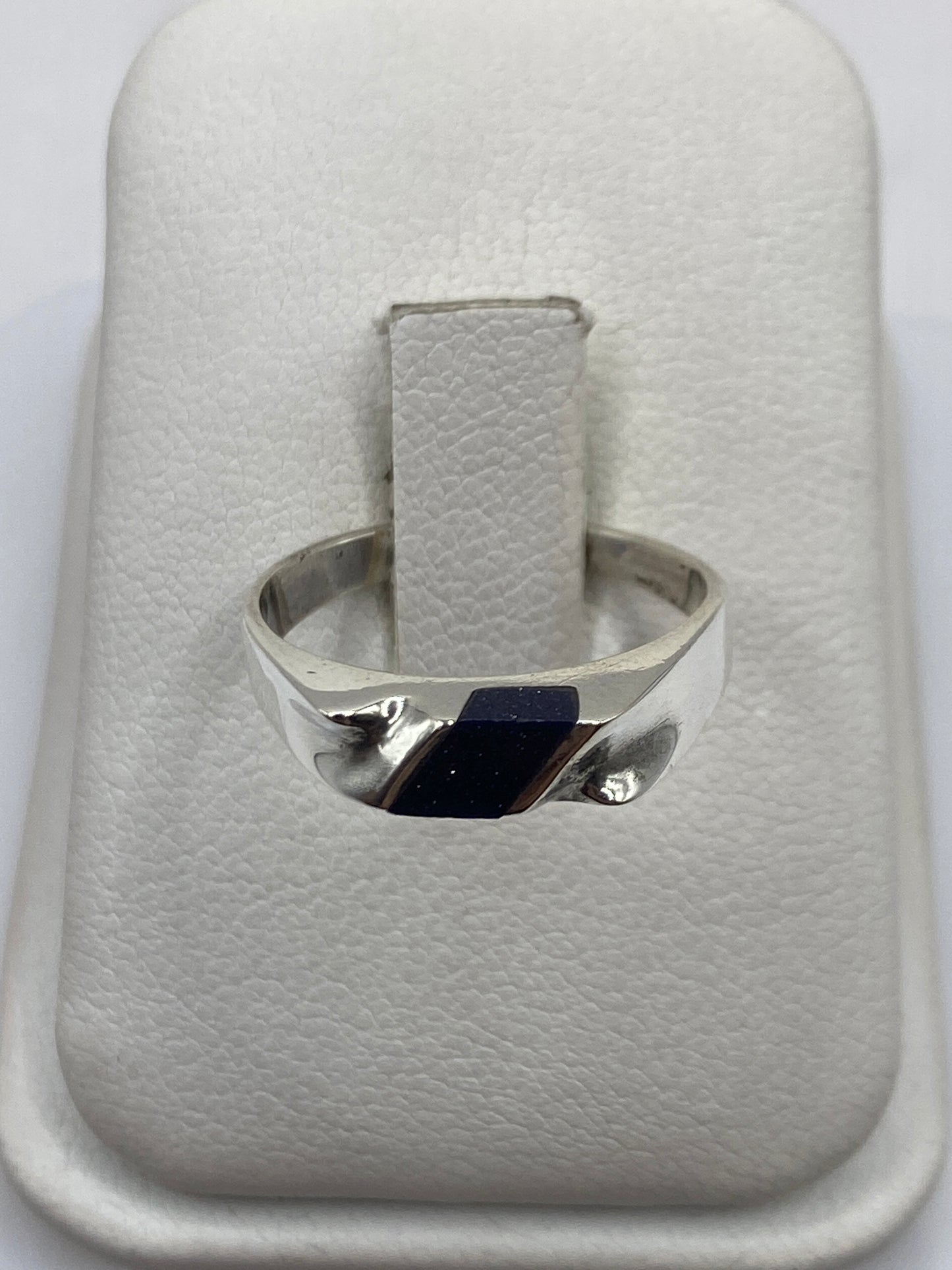 Anillo de plata .925 solitario con piedra negra natural en la mano de una mujer