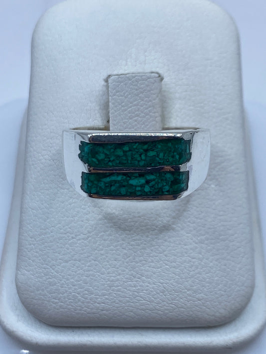 Anillo de plata con dos bandas laterales enmarcando malaquita verde natural