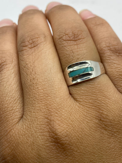 Anillo de turquesa sobre fondo blanco con sello 925 MEXICO visible en la banda